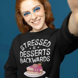 Stressed Is Desserts Spelled Backwards Eat Cake Unisex Heavy Blend™ Crewneck Sweatshirt - sweatshirt mockup of a woman with graphic makeup taking a selfie m - Shujaa Designs